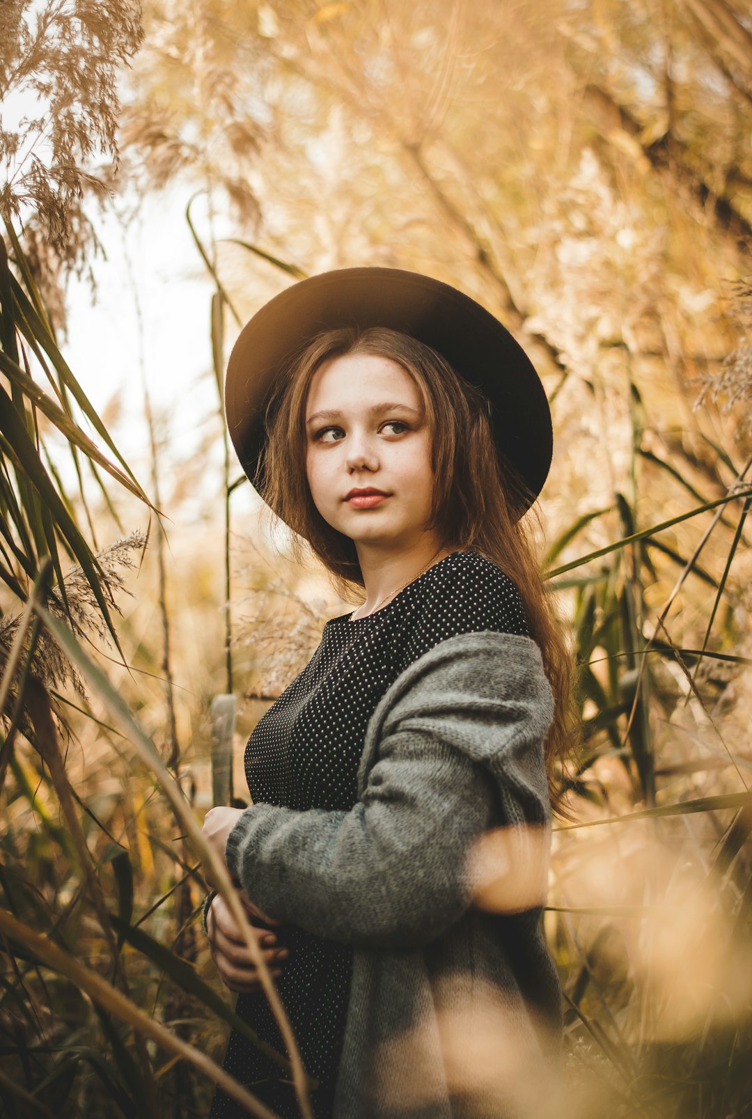 woman in black and white striped long sleeve shirt wearing black hat