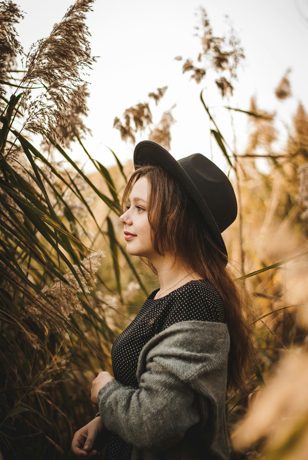 woman in black hat and gray sweater