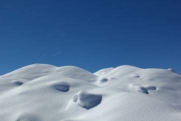 white snow on blue sky