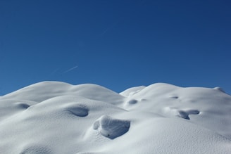 white snow on blue sky