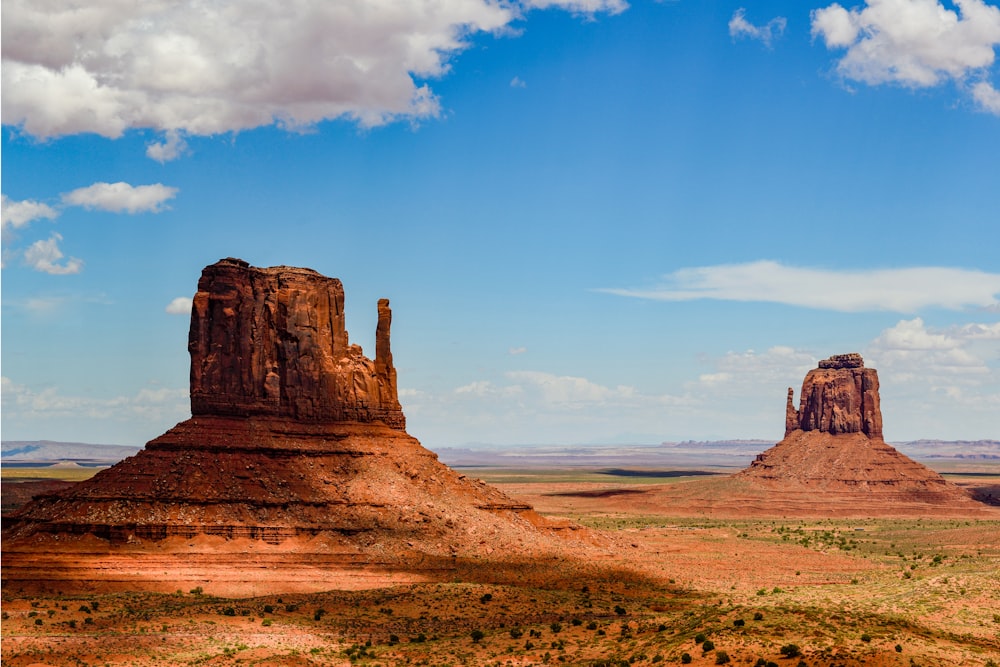 brown rock formation near body of water under blue sky during daytime