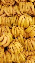 yellow banana fruit on brown wooden table
