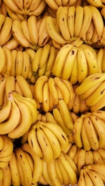 yellow banana fruit on brown wooden table