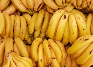 yellow banana fruit on brown wooden table