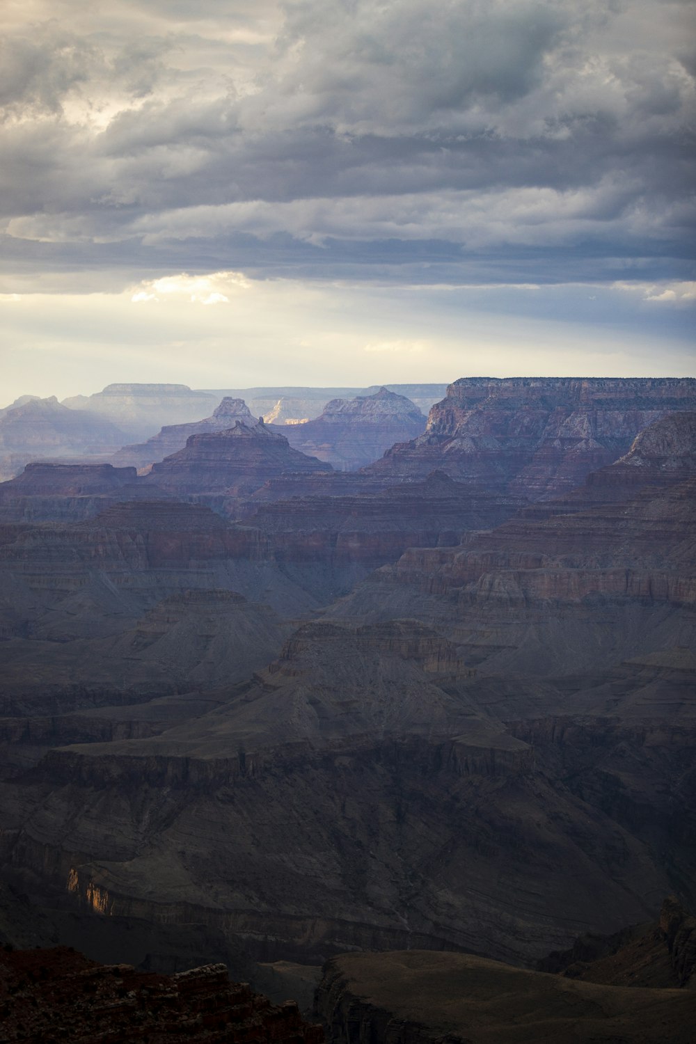 brown rocky mountain under cloudy sky during daytime