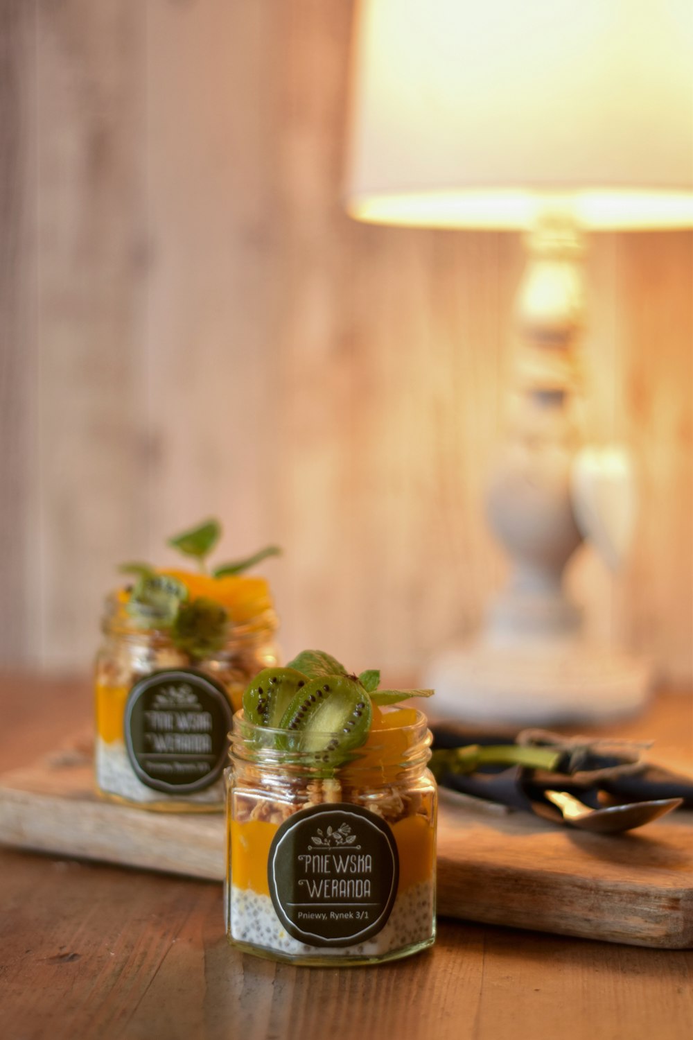 three green and yellow labeled bottles on brown wooden table