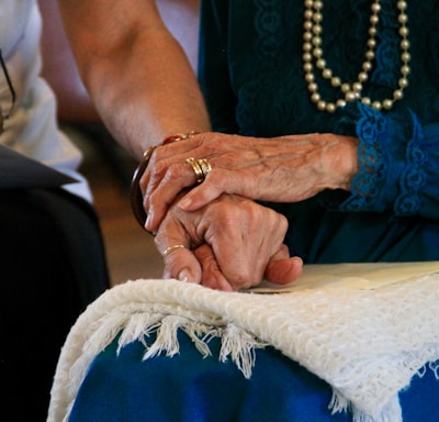 person wearing gold ring and blue dress