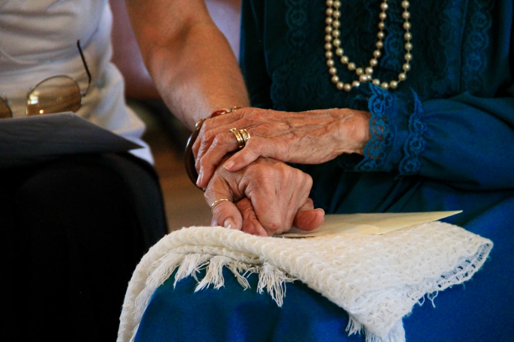 person wearing gold ring and blue dress