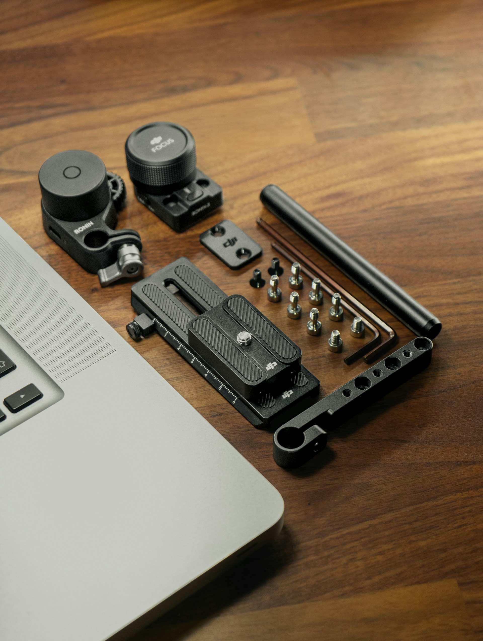 black and silver camera lens beside black and silver laptop computer