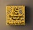 A small yellow canvas displays bold black text that reads 'I'm on the Universe's Payroll' with the artist's signature and date at the bottom. There are blue and gray radial lines emanating from the text, creating a dynamic visual effect.