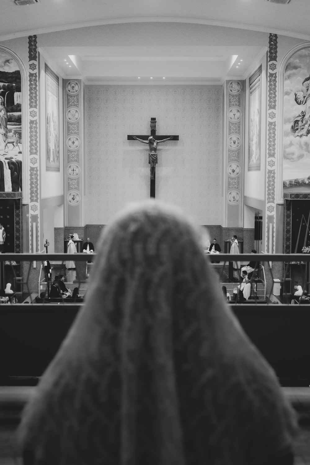 grayscale photo of cross on top of the table