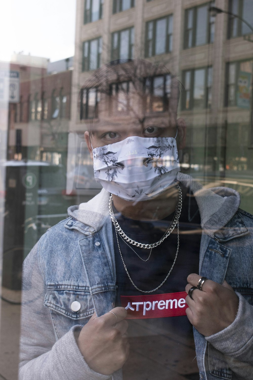 man in blue denim jacket wearing white mask