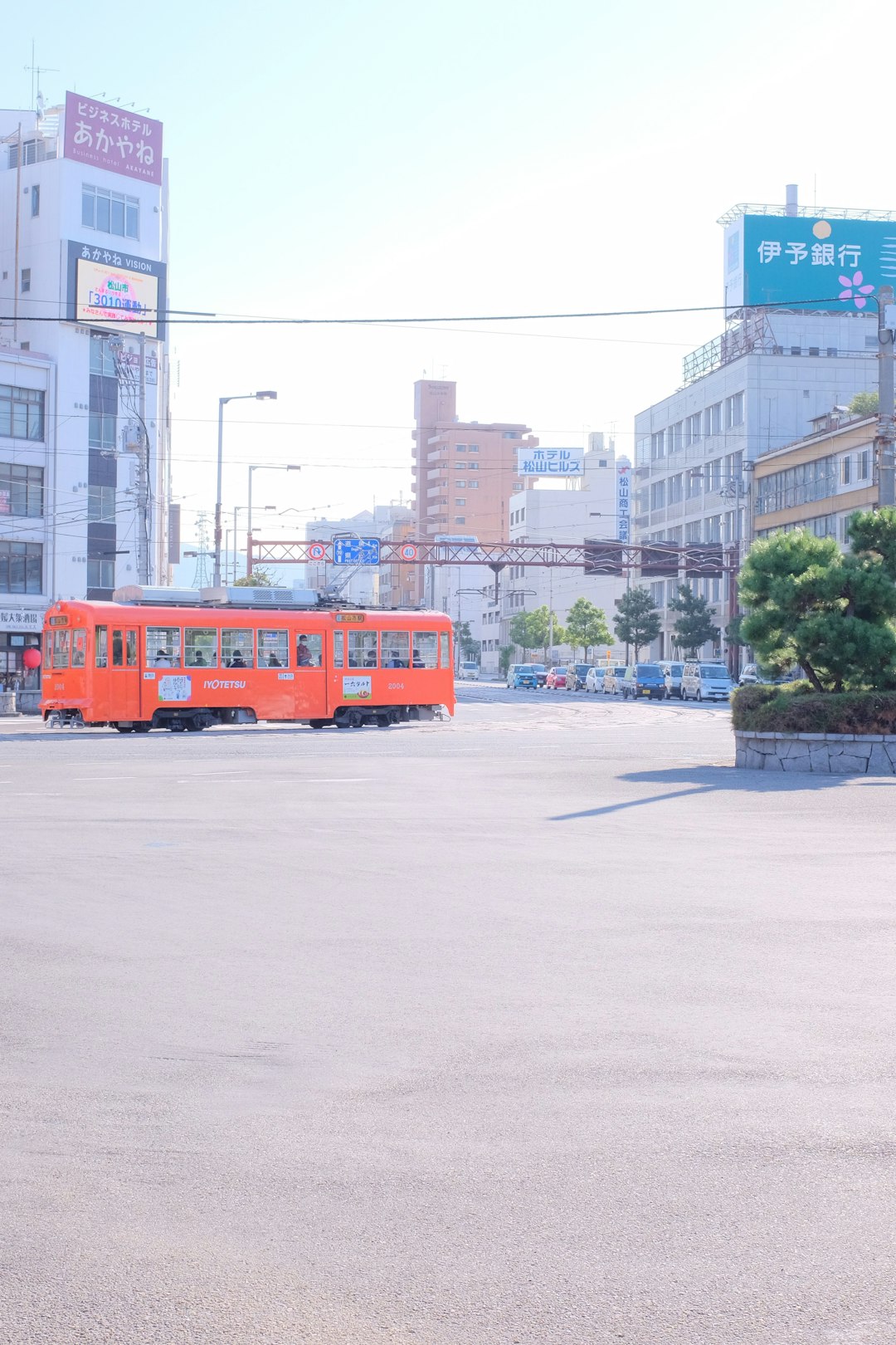red bus on road near building during daytime