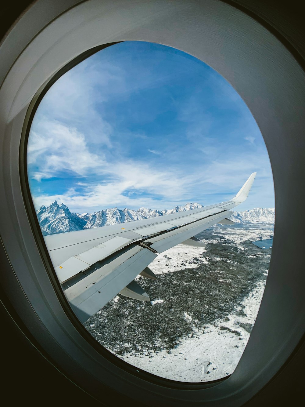 airplane window view of white clouds and blue sky during daytime