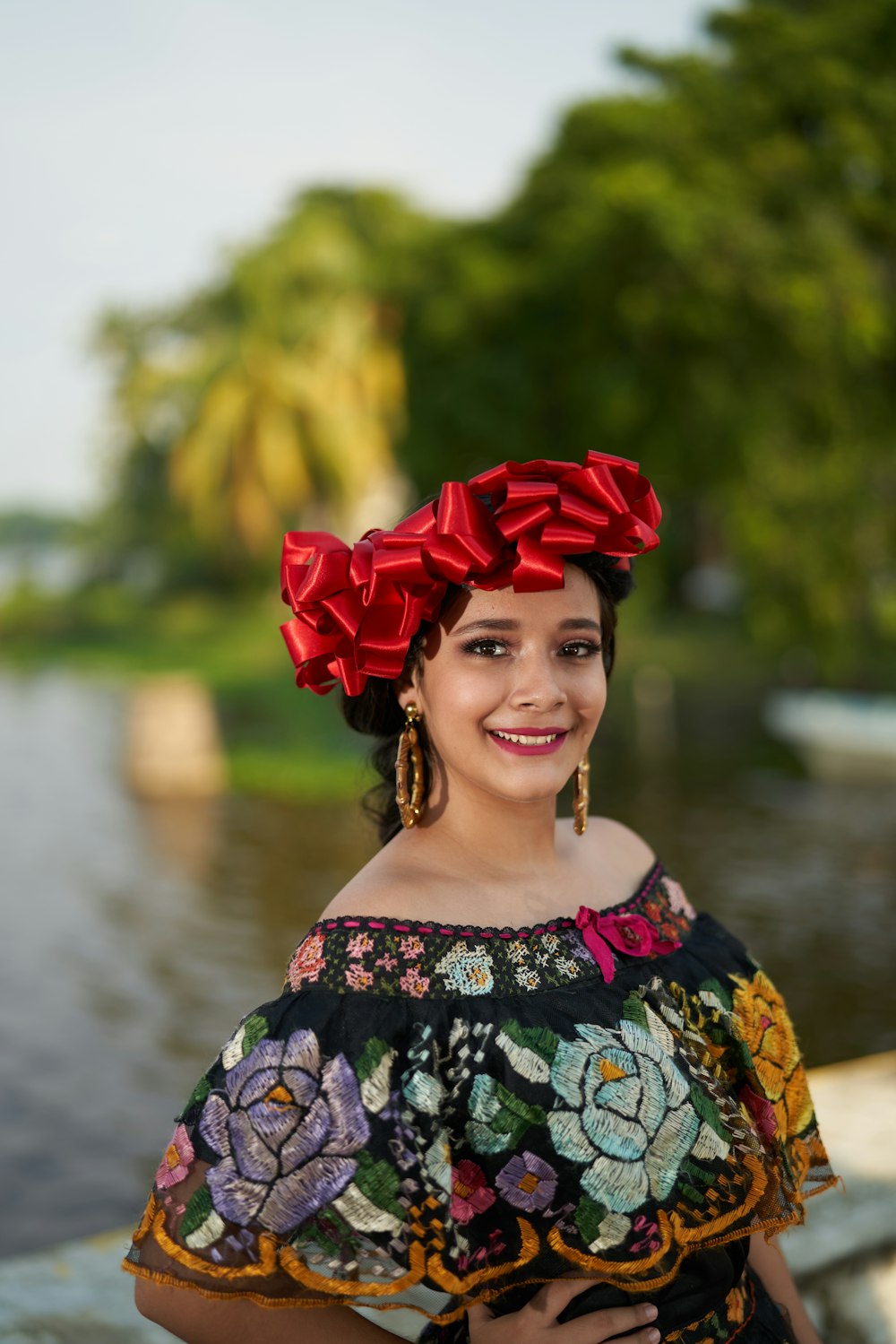 woman in blue and white floral off shoulder dress with red flower on head