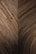 An intricate wooden pattern featuring a geometric design with overlapping planks creating a series of angled and curved sections. The wood is of a deep brown color, showcasing its natural grain and texture.