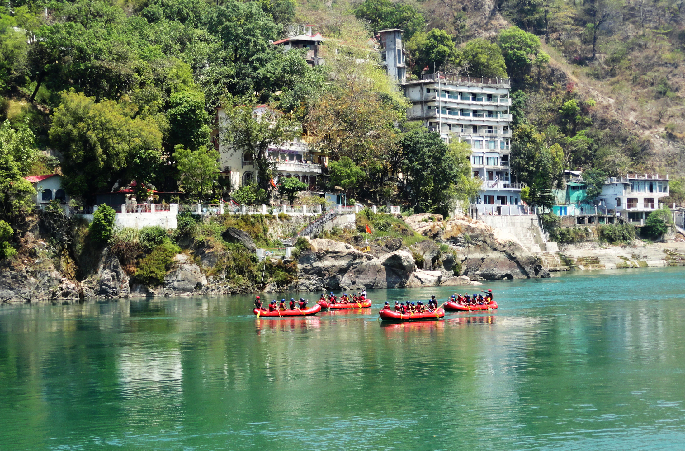 Red rafts on the jade Ganga below the ashrams of Rishikesh