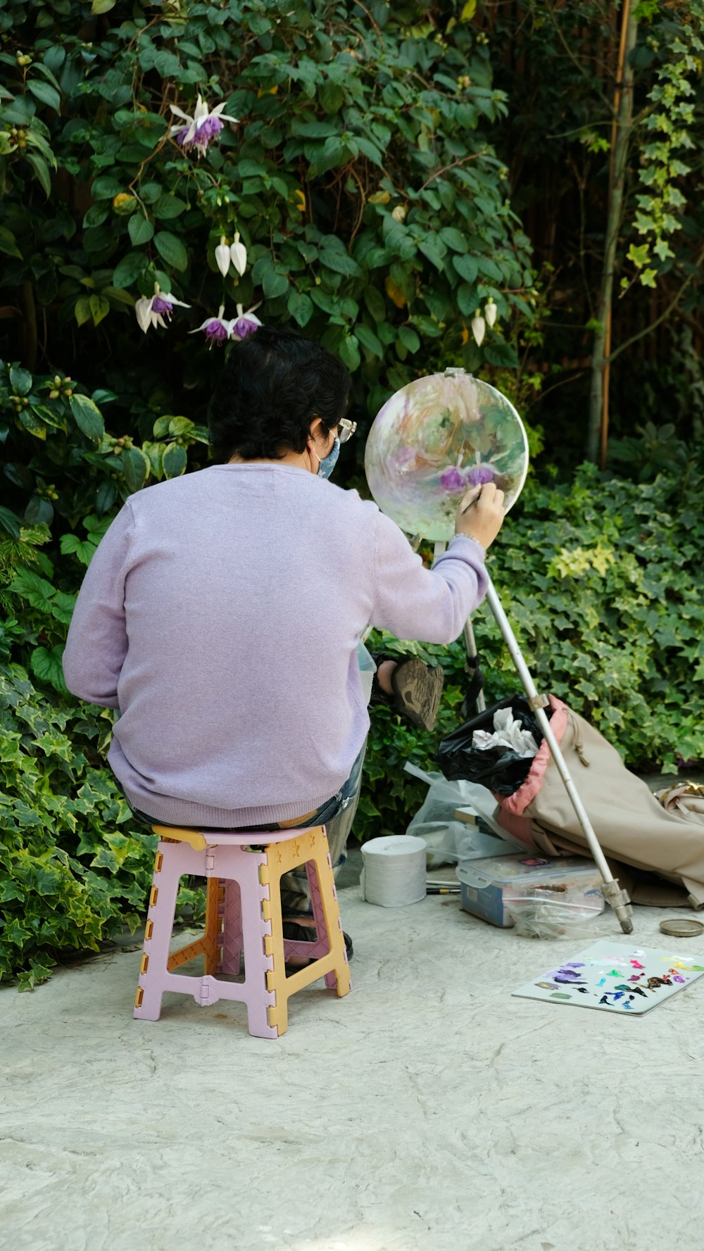 woman in purple long sleeve shirt sitting on brown wooden seat