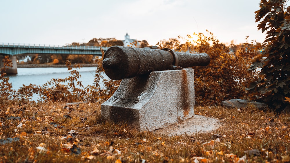 black metal pipe near lake during daytime