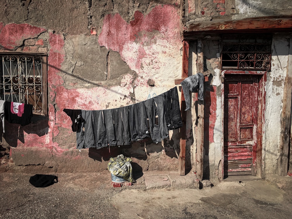 black textile hanged on red brick wall