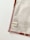 A piece of fabric is neatly laid out with visible stitching along the edges. A small label with the name 'ernestalulu' and a website URL is sewn onto the fabric near the bottom corner. The fabric has a subtle pattern and is bordered with a light brown edge.