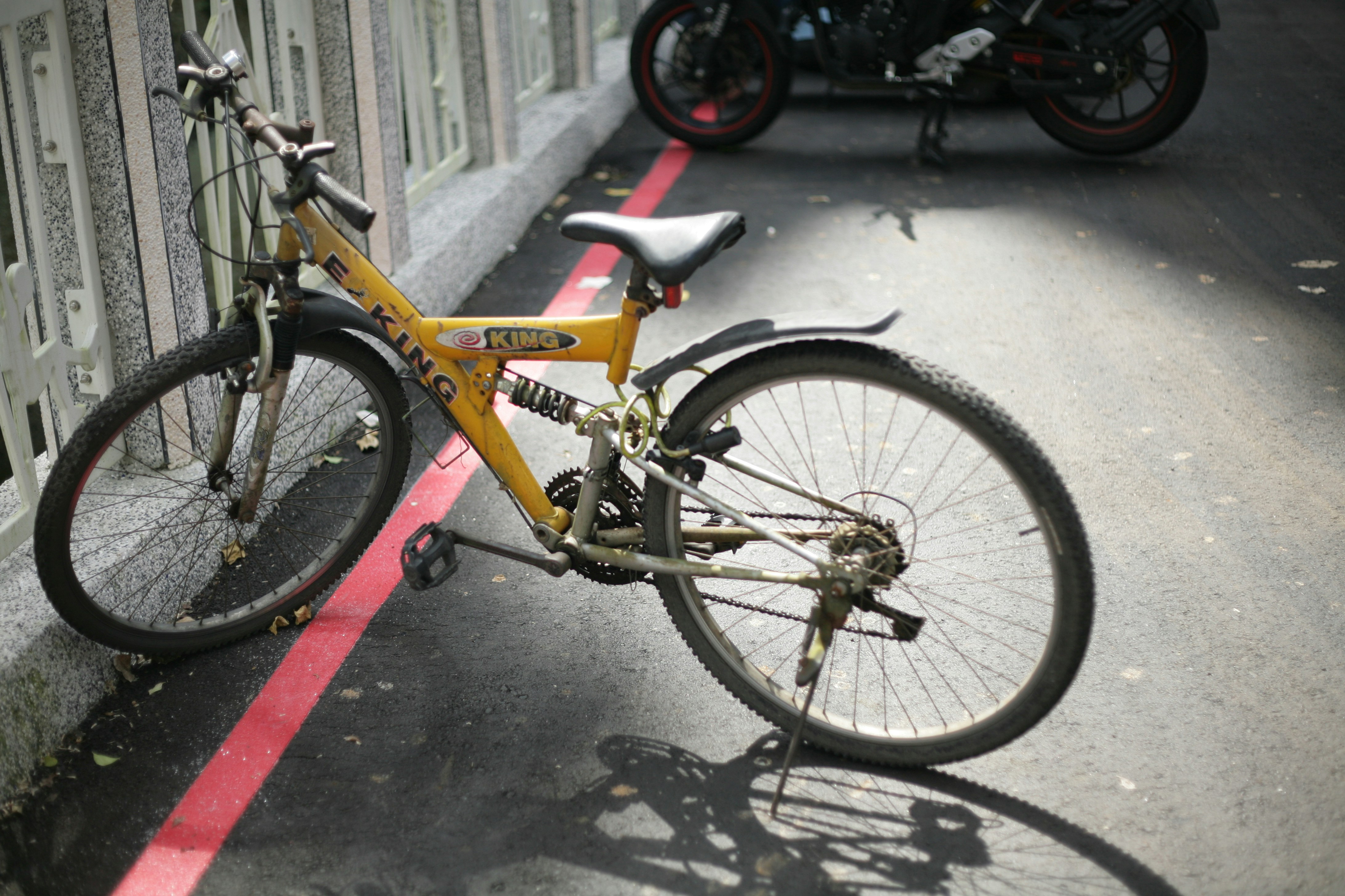 yellow and black bicycle on road
