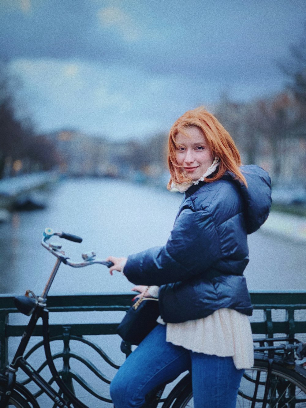 woman in black jacket and white skirt riding on black motorcycle during daytime