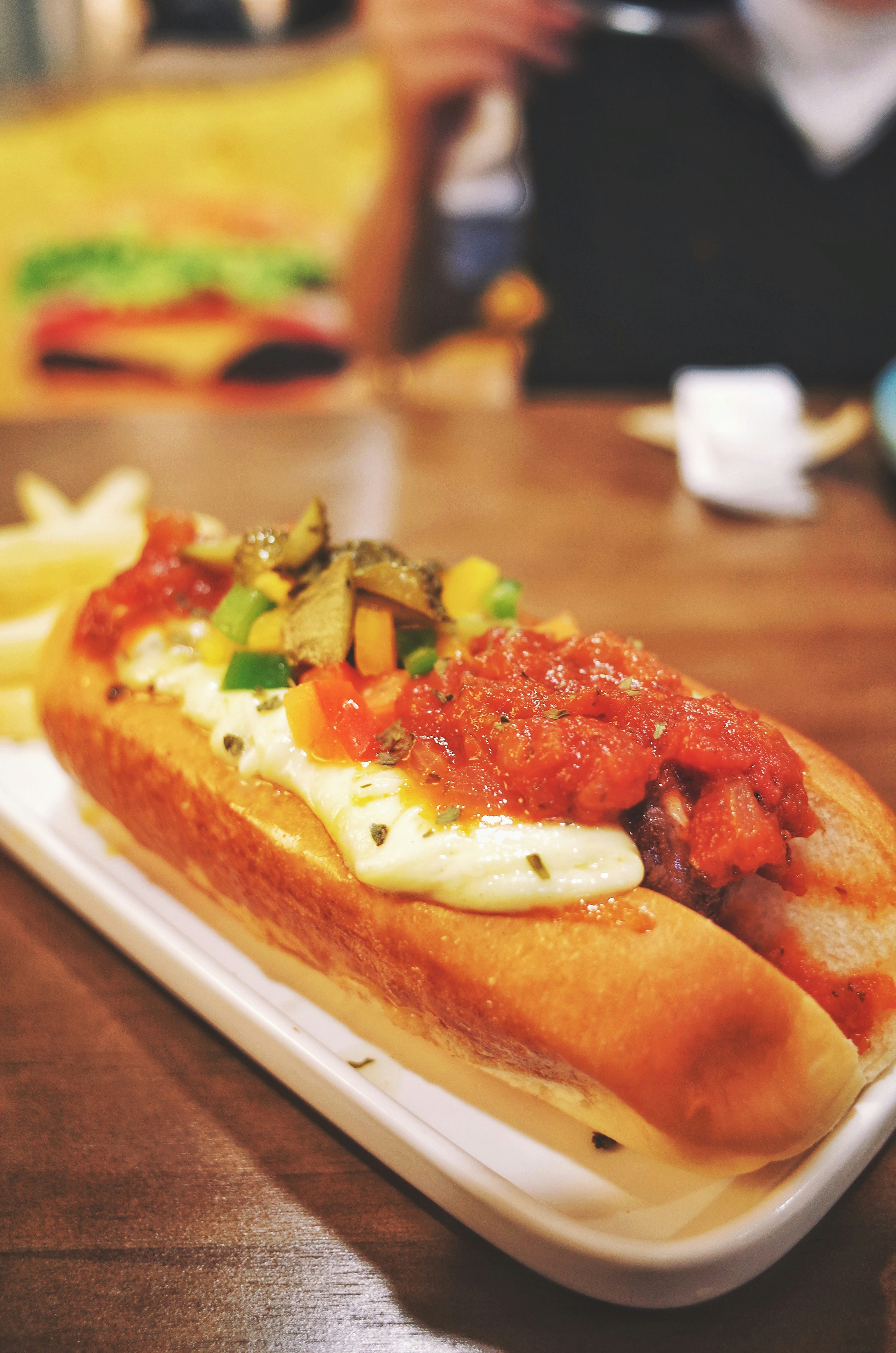 A spicy hotdog with jalapenos and chili.