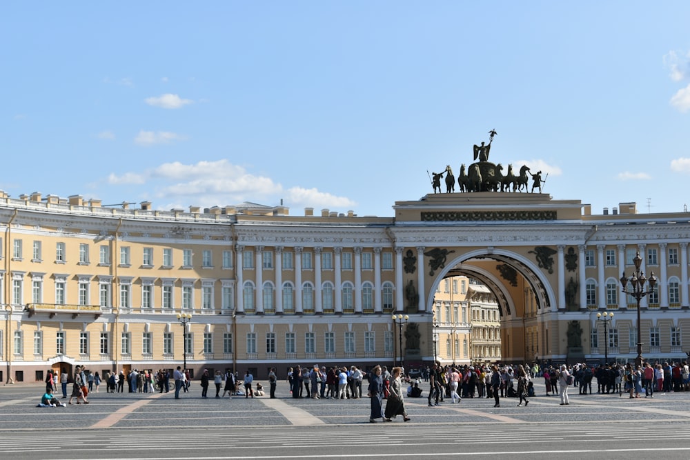 people walking near white concrete building during daytime