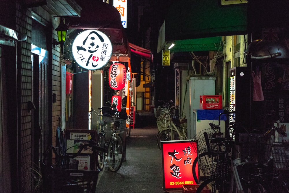 black bicycle parked beside store during night time