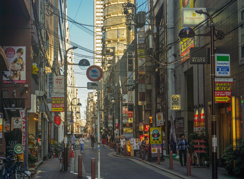 people walking on sidewalk near buildings during daytime