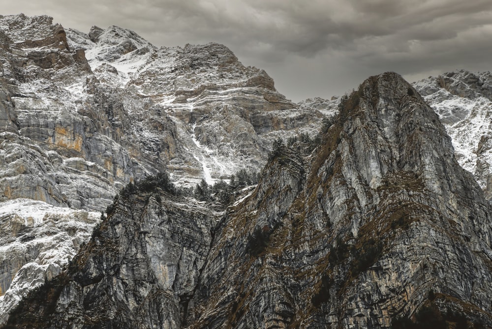 brown and white rocky mountain under white cloudy sky during daytime