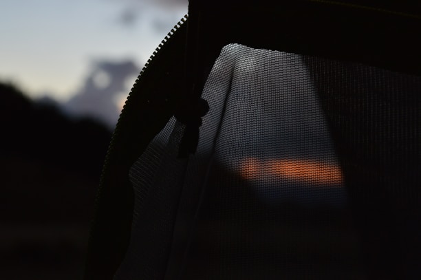 Close-up of Lumina Apparel’s breathable fabric texture with city skyline blurred in background.