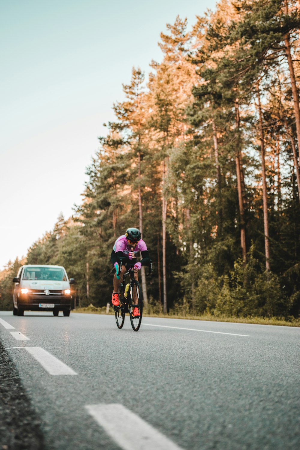 man in red jacket riding bicycle on road during daytime