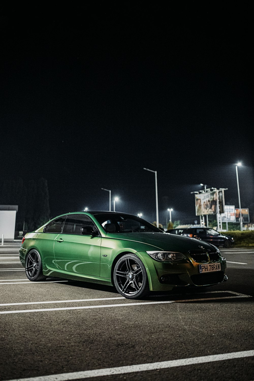 green porsche 911 parked on parking lot during night time