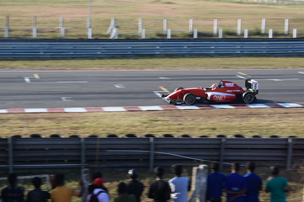 red and black f 1 race car on track during daytime