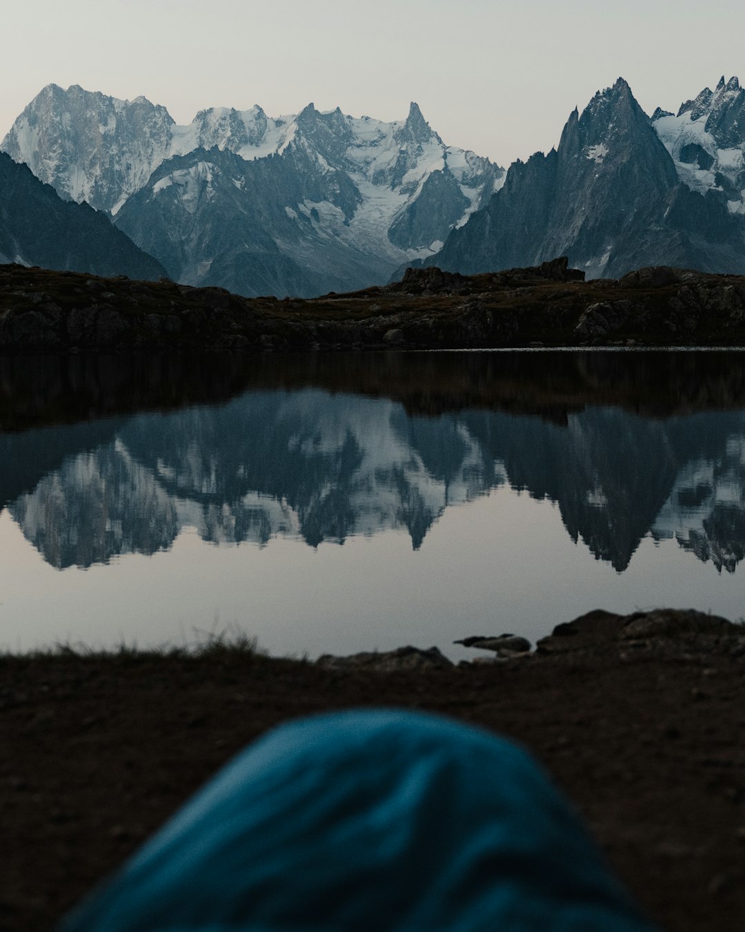 lake near snow covered mountain during daytime