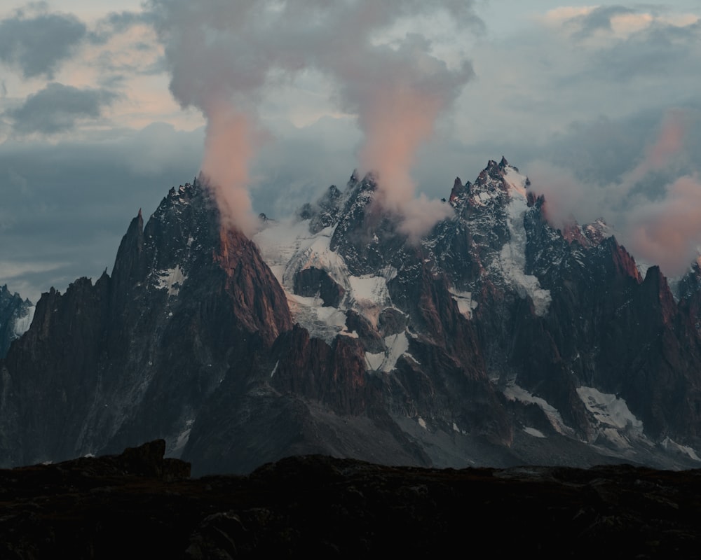 black and white mountain under white clouds