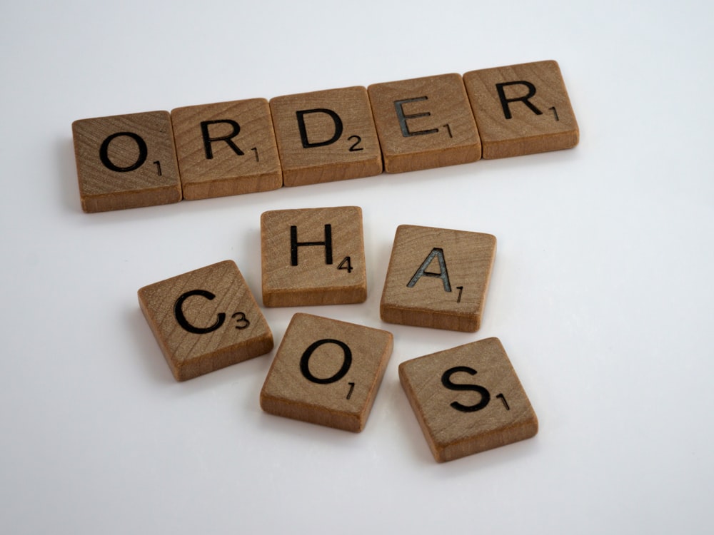 brown wooden letter blocks on white surface