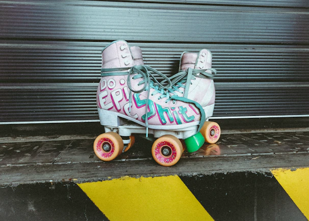 Close-up of colorful skate boot covers displayed on a rack