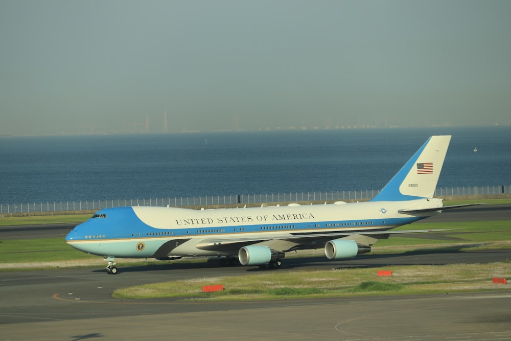 white and blue passenger plane on airport during daytime