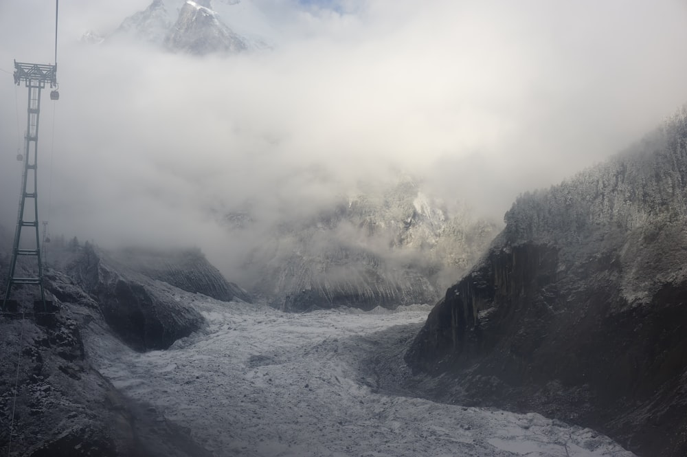 black rocky mountain covered with fog