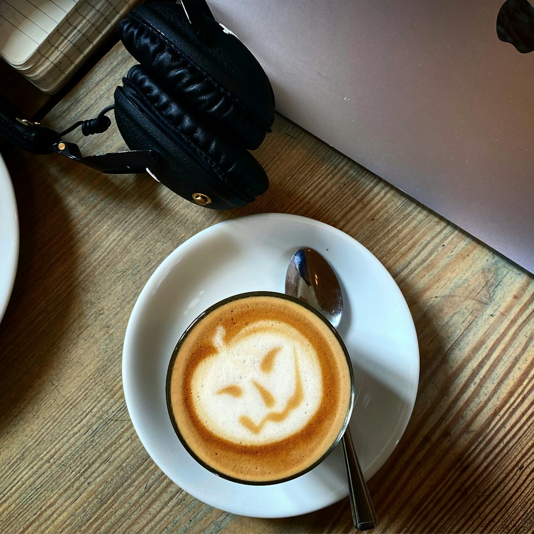 white ceramic cup with saucer on brown wooden table