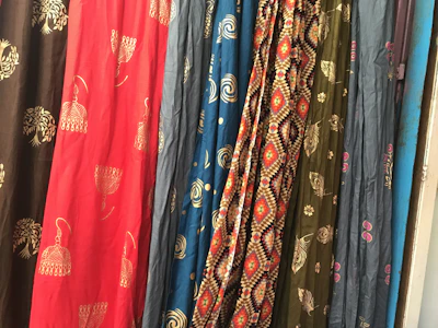 Close-up of colorful fabric samples showcasing sublimation and serigraphy techniques.