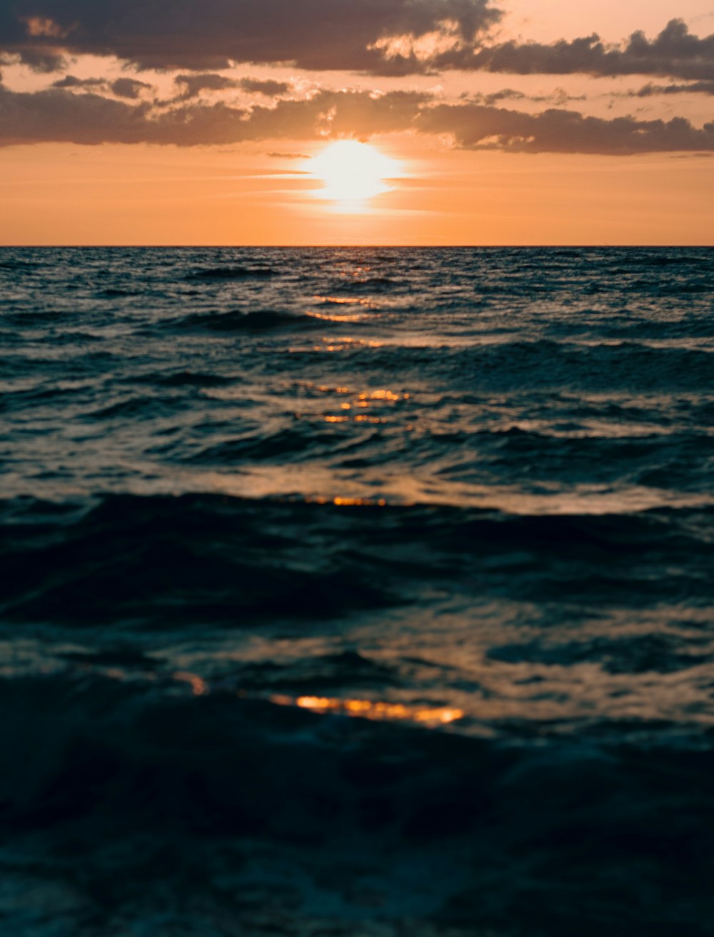 body of water during sunset