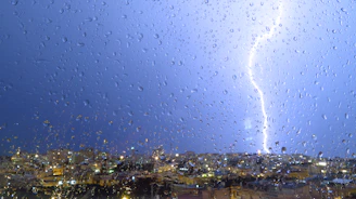 A cinematic shot of a lightning bolt illuminating a dark cityscape at night, capturing Thunder Studio’s electric energy.