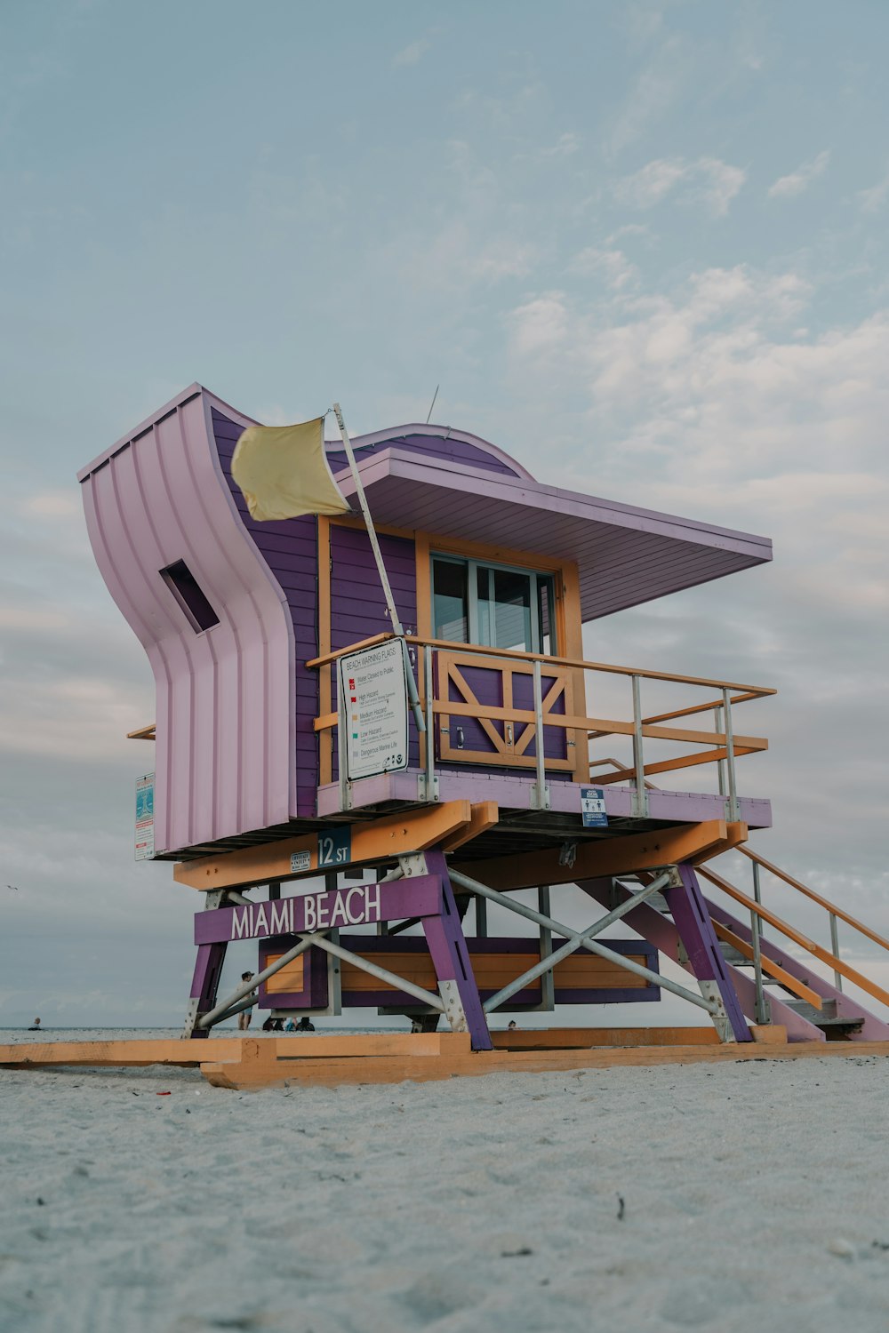 brown wooden lifeguard house on beach during daytime