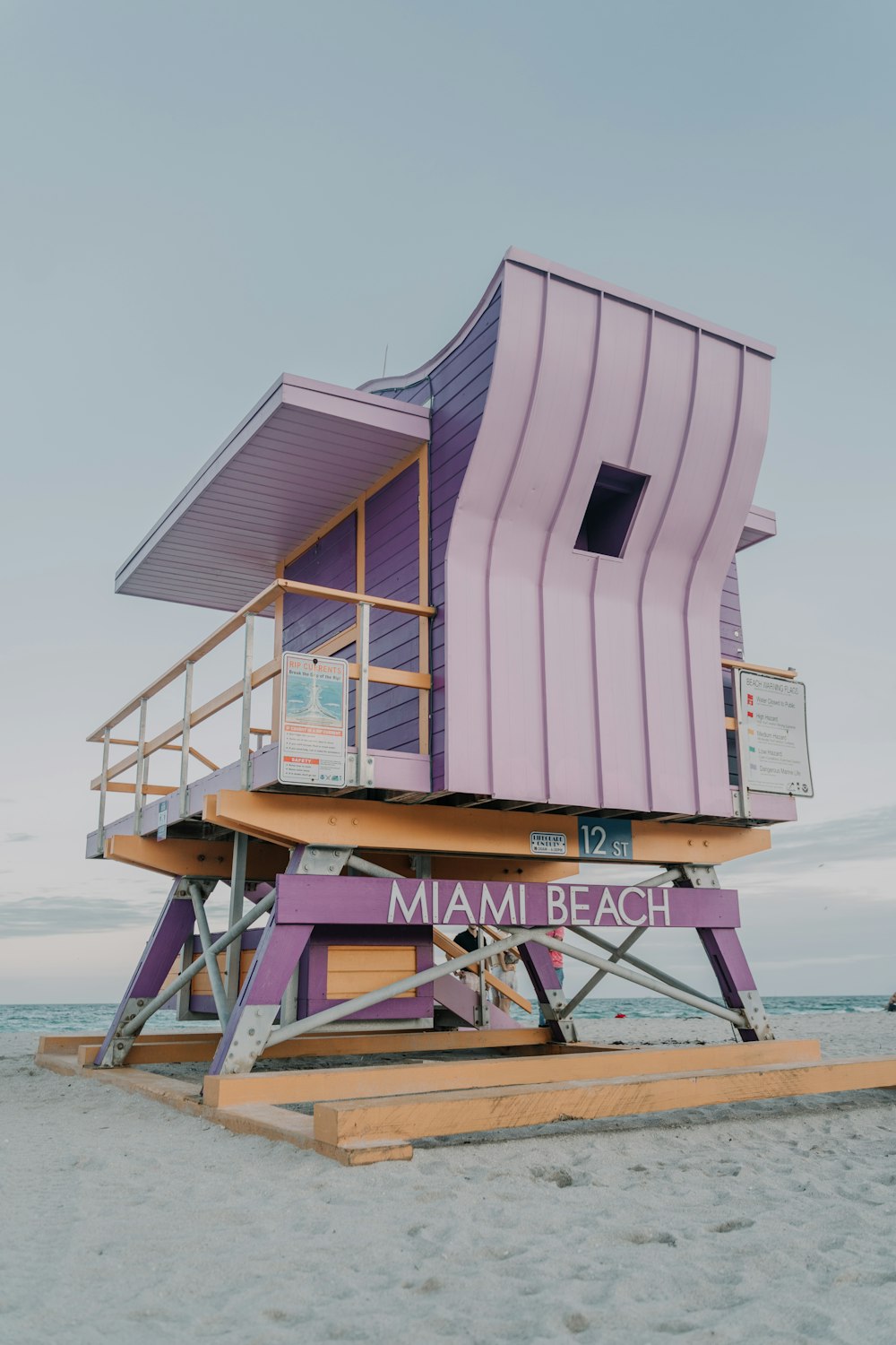 white and brown wooden lifeguard house on beach during daytime