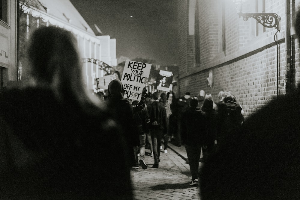 people walking on street in grayscale photography