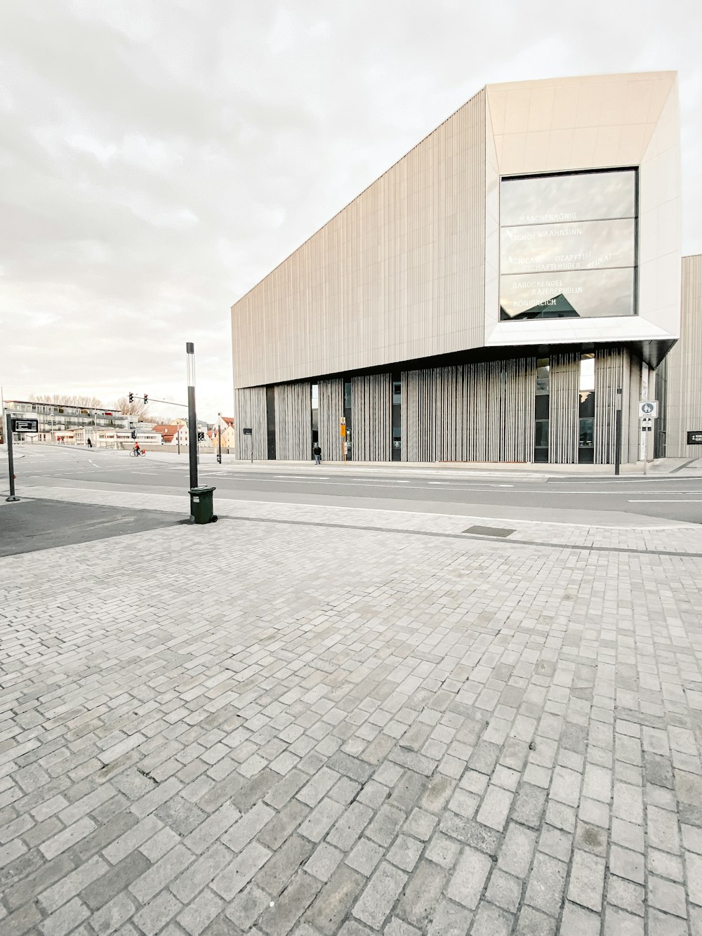 white and black concrete building near road during daytime